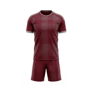 Full front view of a maroon plaid pattern soccer uniform set with grey trim, including jersey and shorts, against a white background.