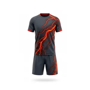 Front and back view of a dark grey lightning soccer uniform set with vibrant red and orange lightning bolt graphics.