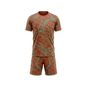 Front view of terracotta and teal mosaic pattern soccer uniform with short-sleeve jersey and matching shorts for team sports.